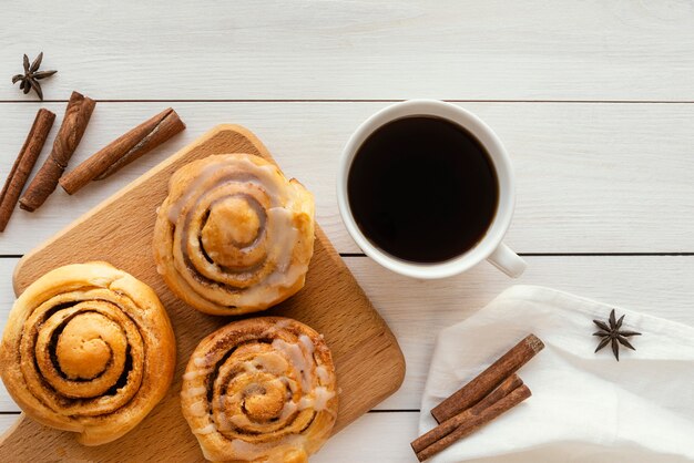 Top view cinnamon roll and coffee cup