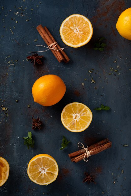 Top view cinnamon sticks with orange on the table