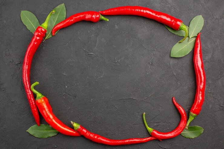 Free Photo top view circle of red hot peppers and pay leaves on black surface