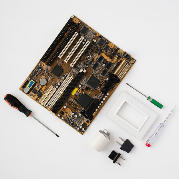 Top view of circuit board and electrical equipment on white surface