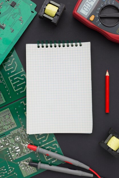 Top view circuit board with a blank notepad