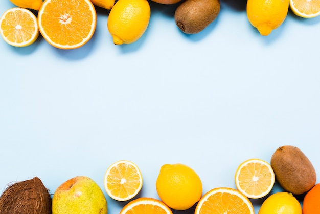 Top view of citrus fruits, coconut and kiwis