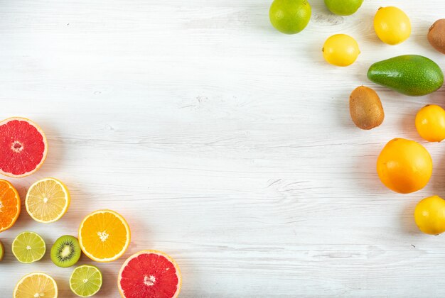 Top view citrus fruits kiwi green and yellow lemon grapefruit orange with copy space