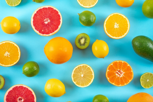 Top view citrus fruits pattern on blue surface