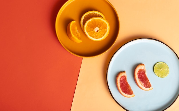 Free photo top view citrus on plates arrangement