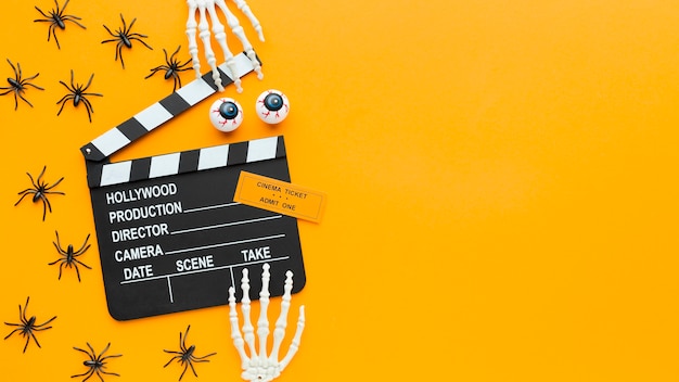 Top view clapperboard and spiders with copy space