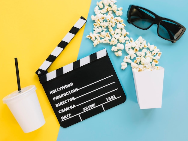 Top view clapperboard with popcorn on the table