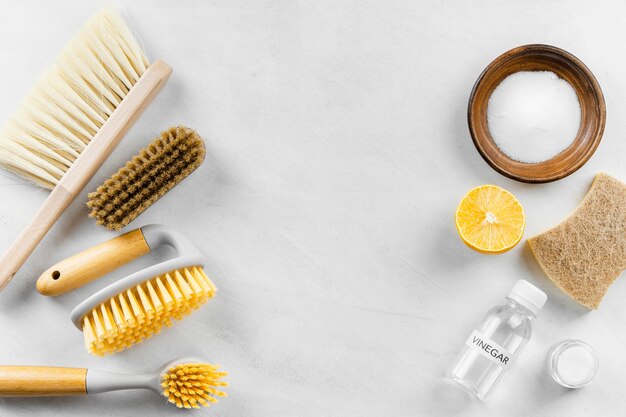 Top view of cleaning brushes with baking soda and lemon