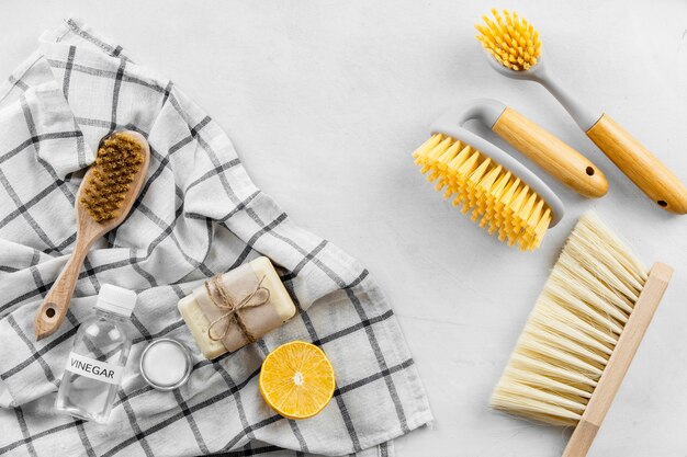 Top view of cleaning brushes with lemon and soap