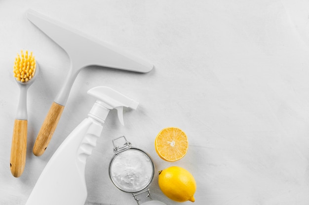 Top view of cleaning products with baking soda and lemon