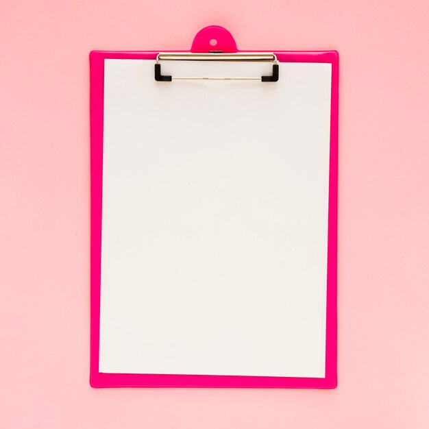 Top view of clipboard mock-up with pink background