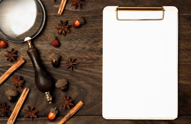 Top view clipboard with magnifying glass on the table