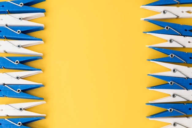 top view clothes pegs with yellow background