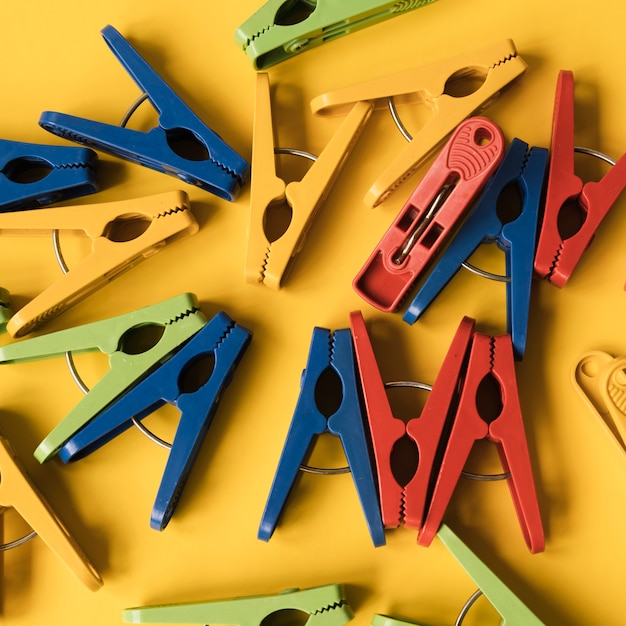 Free photo top view clothespin with yellow background