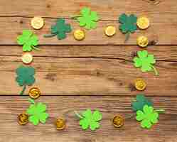 Free photo top view clovers and gold coins arrangement