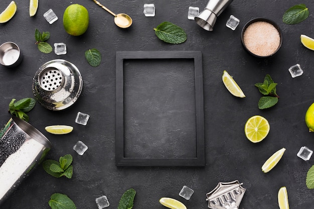 Top view of cocktail essentials with frame and mint
