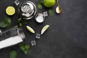 Free photo top view of cocktail essentials with lime and copy space