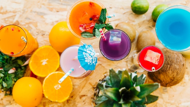 Top view of cocktail and tropical fruits