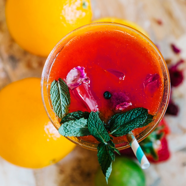 Top view of cocktail and tropical fruits