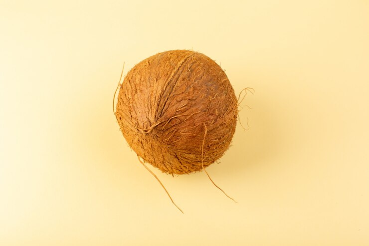 Free Photo a top view coconut whole milky fresh mellow isolated on the cream colored