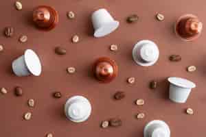 Free photo top view coffee beans and coffee capsules