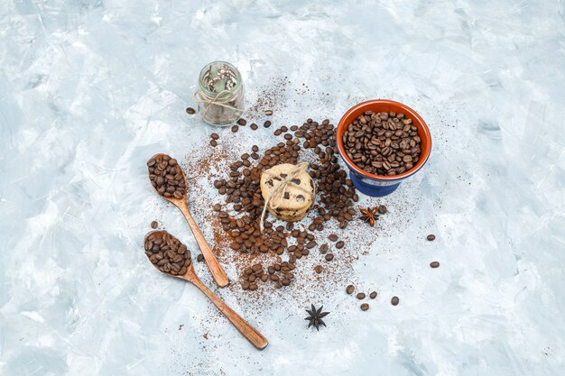 Top view coffee beans and spices on grunge background