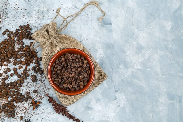 Top view coffee beans and spices on grunge background