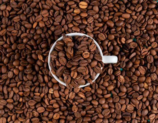 Top view coffee beans with cup  surface