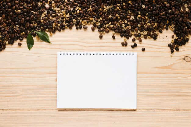Top view of coffee beans with notebook mock-up