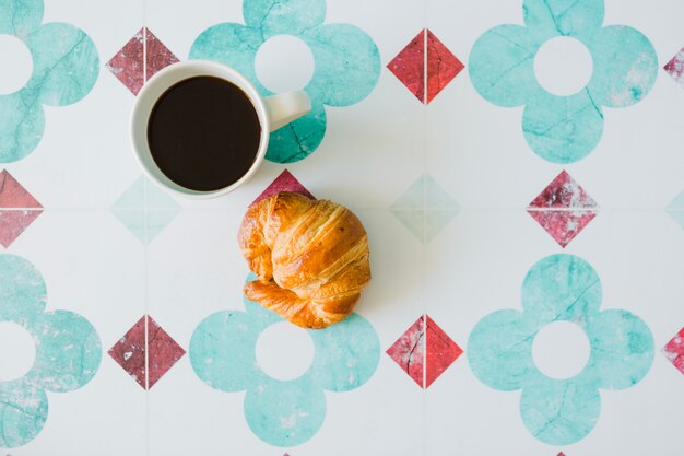 Top view of coffee and croissant