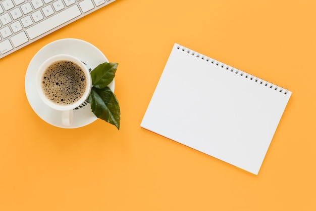 Top view of coffee cup and notebook