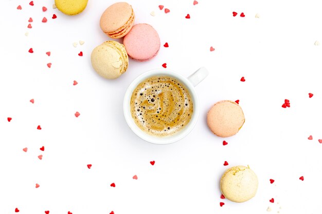 Top view of coffee cup with macarons for valentines day