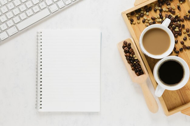 Top view of coffee cups with notebook