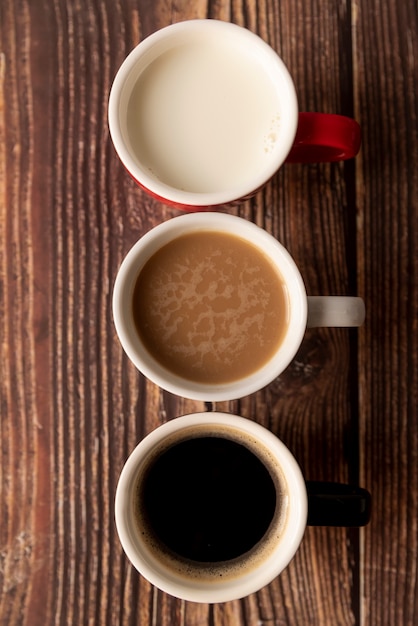 Top view coffee in degrade on wooden table