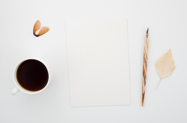 Free photo top view coffee with paper and autumn leaves