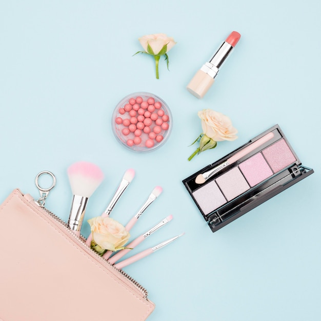 Top view collection of beauty products on blue background