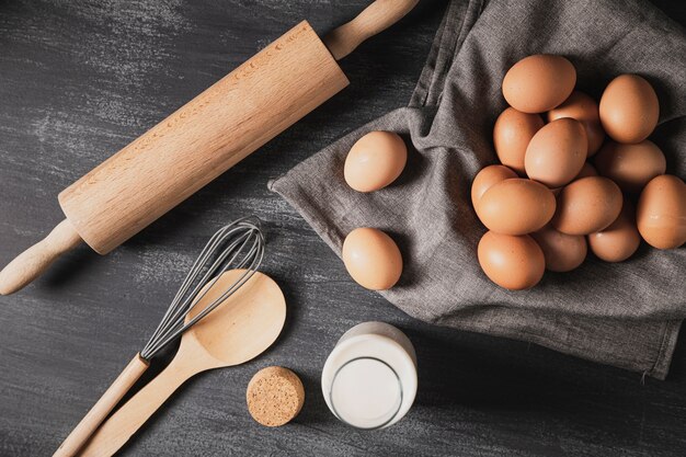 Top view collection of cooking tools next to eggs 