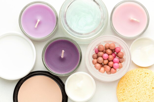 Top view collection of cosmetic products and candles