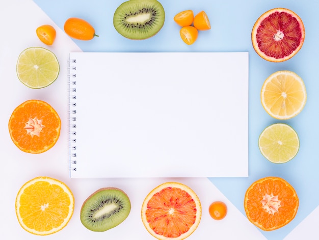 Top view collection of fresh fruits with notebook