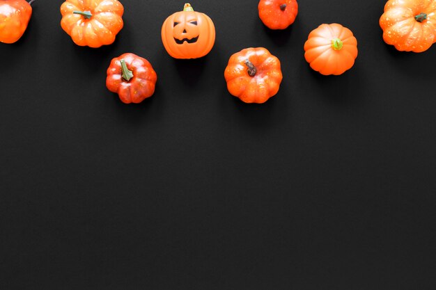 Top view collection of halloween pumpkins with copy space