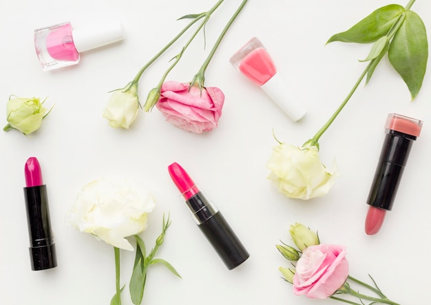 Top view collection of make-up accessories with flowers