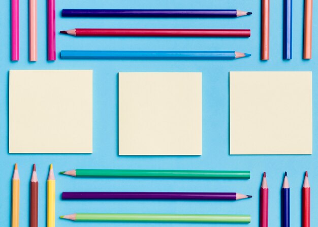 Top view collection of sticky notes and pencils