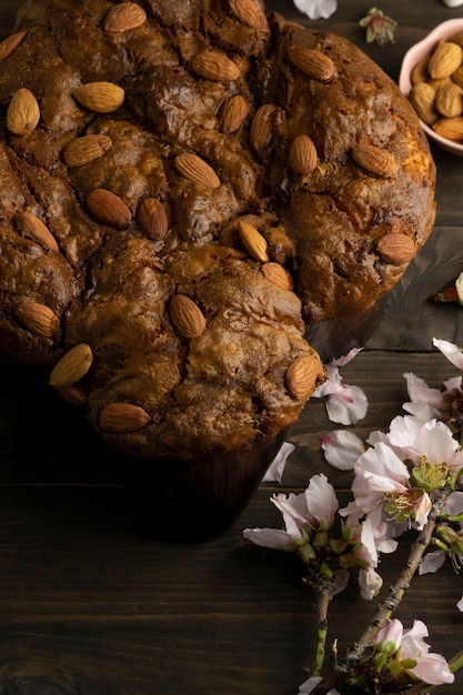 Top view colomba with almonds and flowers