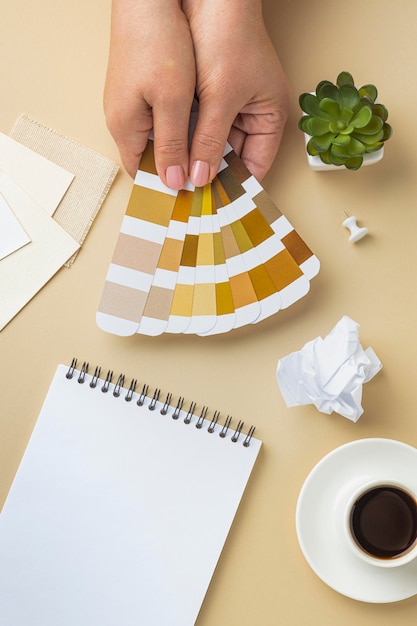 Free photo top view of color palette for house renovation with notebook