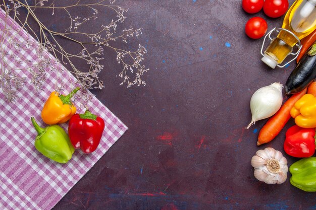 Top view colored bell-peppers fresh vegetables on grey surface vegetable pepper spicy hot food