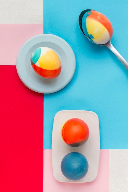 Top view of colored eggs on plate for easter with spoon