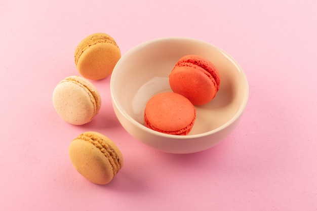 Free photo a top view colored french macarons inside and outside