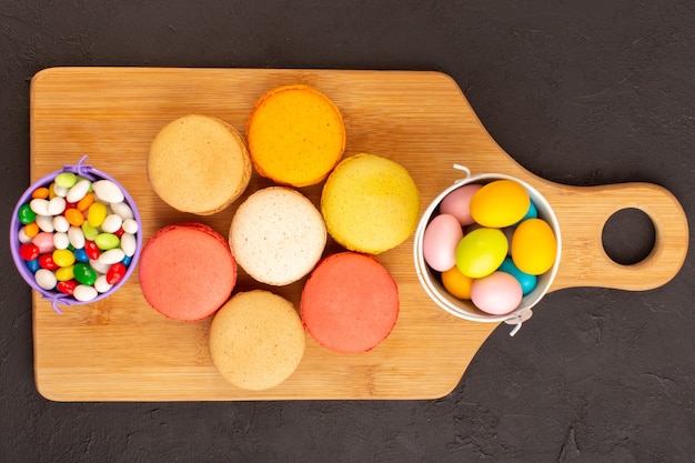 A top view colored french macarons with yummy candies