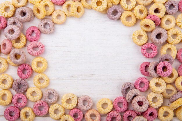 Top view of colored loop and healthy cereals on white with copy space