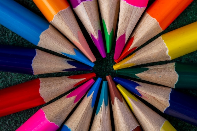 Top view of colored pencils on dark